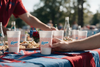 MADdesign Ole Miss Rebels foam party cups with team graphics held at an outdoor tailgate gathering.