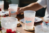 MADdesign Ole Miss Rebels frost flex cups with red team cheers and blue logo on a wooden table at a party